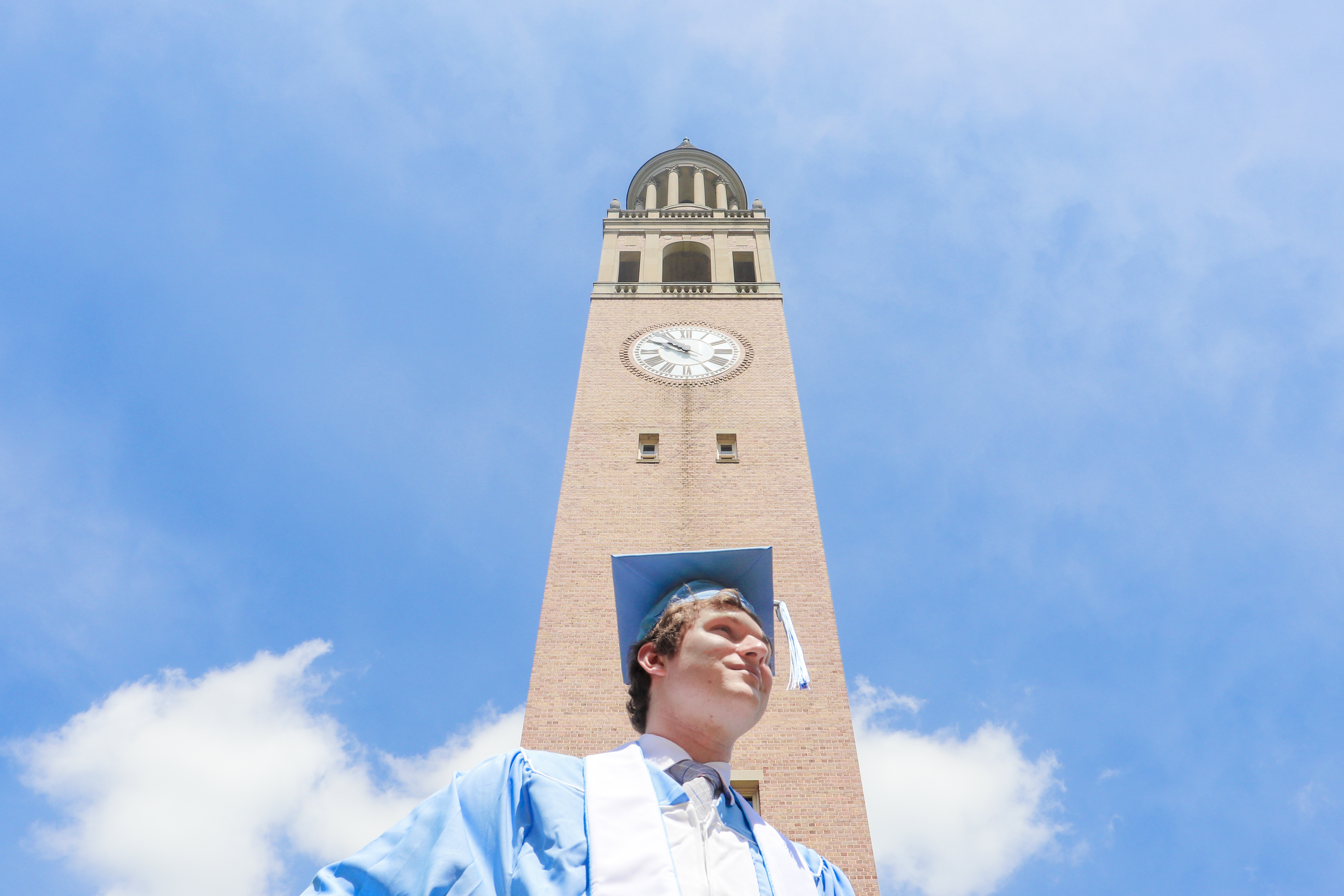 UNC Graduate in front of the UNC bell tower